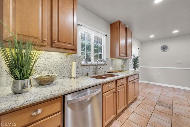 kitchen featuring light tile patterned floors, a sink, dishwasher, decorative backsplash, and light stone counters