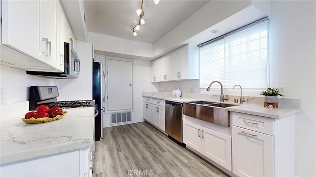 11725 Lemay St Unit 1, North Hollywood, CA 91606 - kitchen with white cabinetry, light countertops, stainless steel appliances, and visible vents
