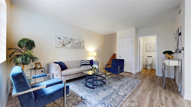 11725 Lemay St Unit 1, North Hollywood, CA 91606 - living area with light wood finished floors, visible vents, baseboards, and stairs