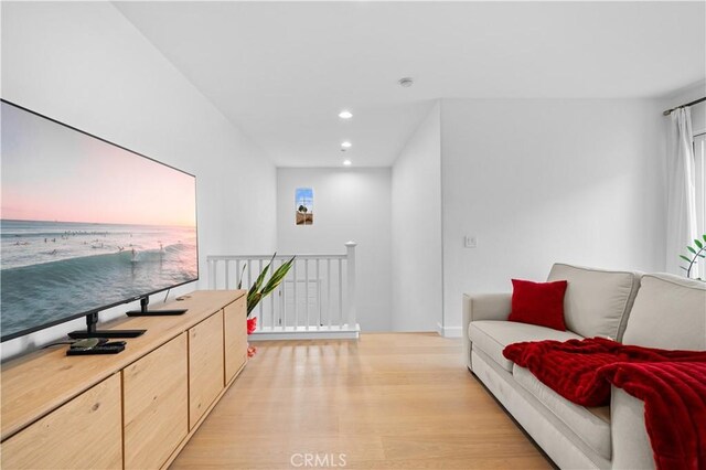 living room with light wood-type flooring, recessed lighting, and baseboards