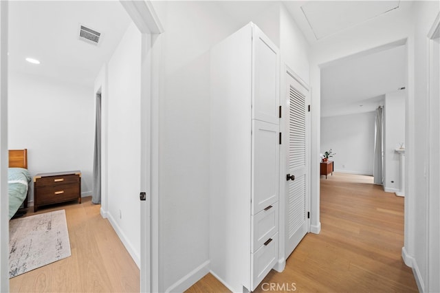 hall featuring light wood finished floors and baseboards