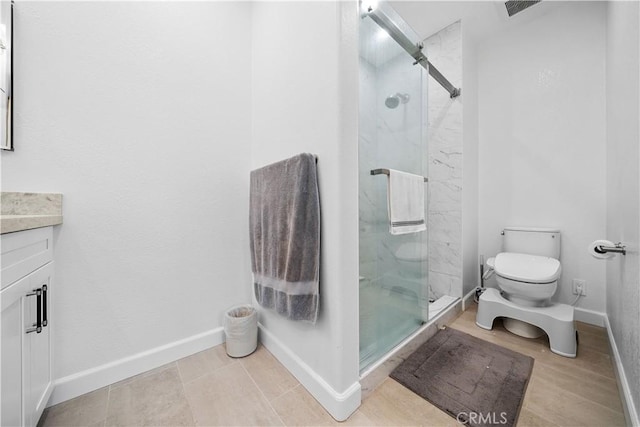 bathroom featuring a marble finish shower, baseboards, toilet, and vanity