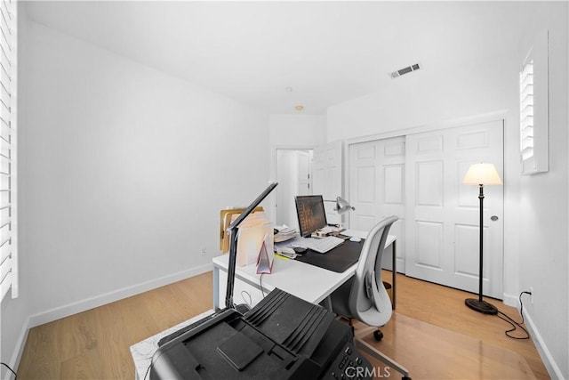 office area featuring light wood-style flooring and baseboards