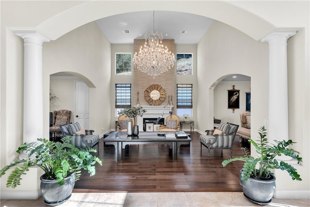 9420 Oak Leaf Dr, Chatsworth, CA 91311 - living room with an inviting chandelier, a towering ceiling, wood-type flooring, and baseboards