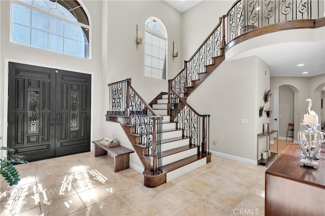 9420 Oak Leaf Dr, Chatsworth, CA 91311 - entryway featuring a towering ceiling, stairs, arched walkways, and baseboards