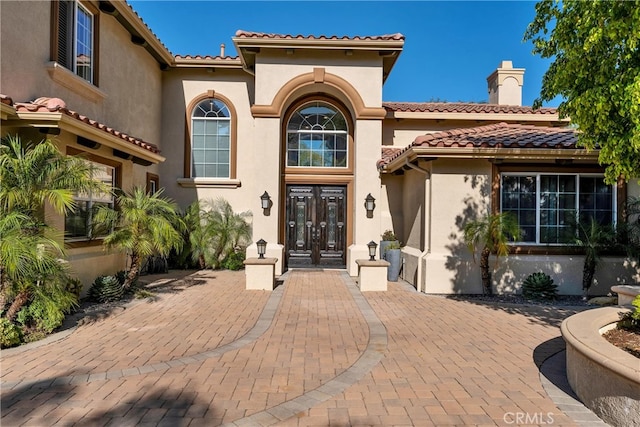 9420 Oak Leaf Dr, Chatsworth, CA 91311 - view of front of property with a tiled roof, stucco siding, french doors, and a chimney