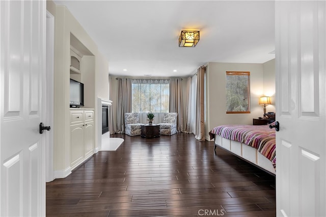 9420 Oak Leaf Dr, Chatsworth, CA 91311 - bedroom featuring dark wood-style floors and a glass covered fireplace