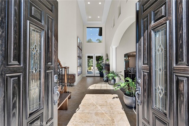 9420 Oak Leaf Dr, Chatsworth, CA 91311 - tiled foyer featuring a high ceiling, a wealth of natural light, arched walkways, and ornate columns