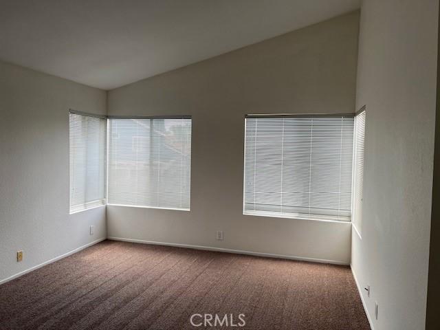 7215 Goldboro Ln, Riverside, CA 92506 - carpeted empty room with vaulted ceiling and baseboards