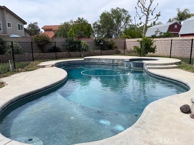 7215 Goldboro Ln, Riverside, CA 92506 - view of swimming pool featuring a fenced backyard and a pool with connected hot tub