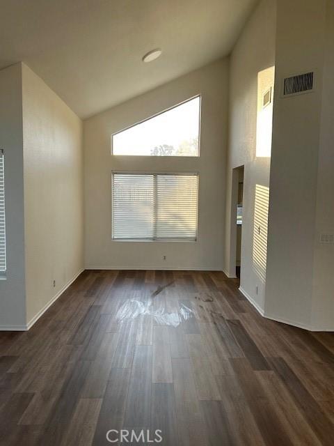 7215 Goldboro Ln, Riverside, CA 92506 - unfurnished living room featuring dark wood-type flooring and high vaulted ceiling