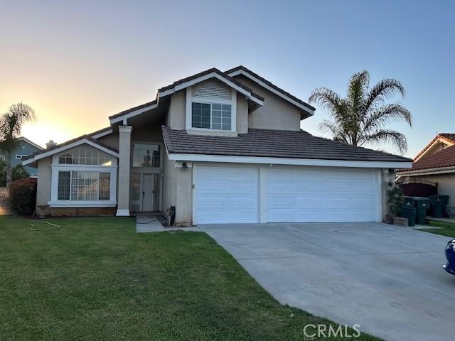 7215 Goldboro Ln, Riverside, CA 92506 - view of front facade with stucco siding, driveway, and a yard
