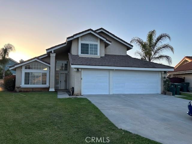 7215 Goldboro Ln, Riverside, CA 92506 - view of front of property featuring stucco siding, concrete driveway, and a front yard
