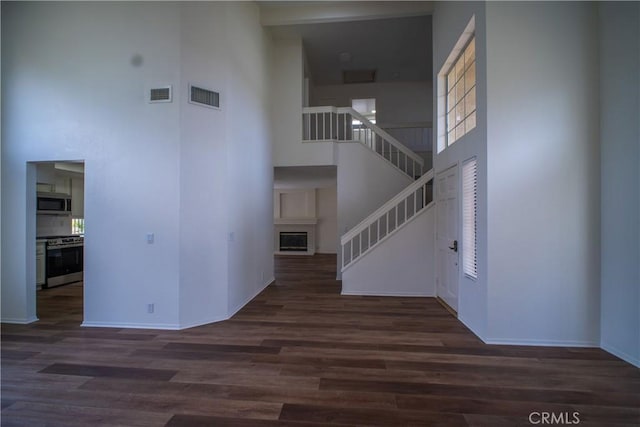 7215 Goldboro Ln, Riverside, CA 92506 - stairway with a towering ceiling and wood finished floors