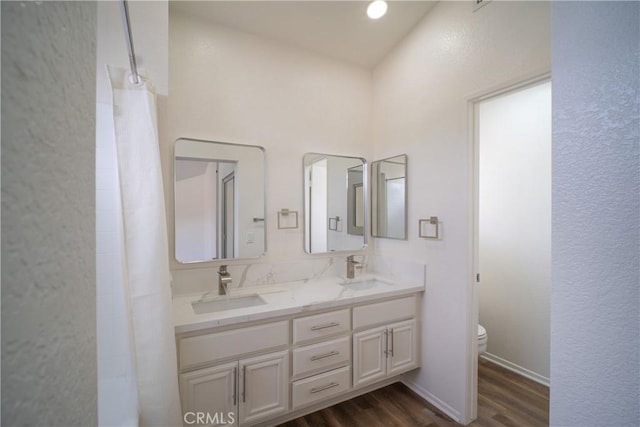 7215 Goldboro Ln, Riverside, CA 92506 - full bathroom featuring wood finished floors and double vanity