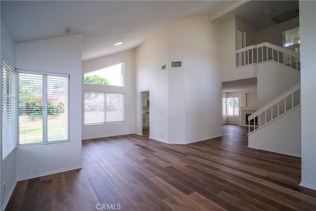 7215 Goldboro Ln, Riverside, CA 92506 - unfurnished living room featuring stairway, dark wood-style flooring, high vaulted ceiling, beamed ceiling, and recessed lighting