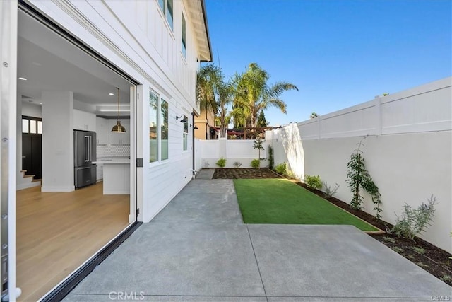 view of yard featuring a patio and a fenced backyard