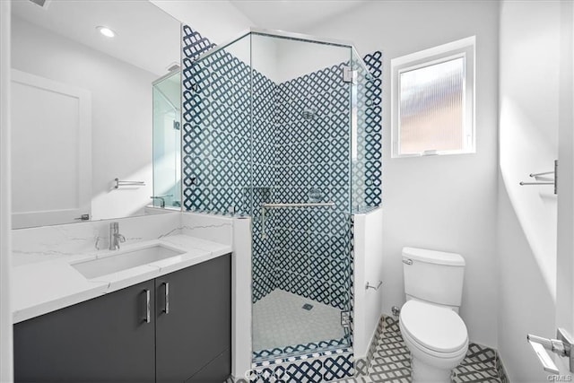 bathroom featuring vanity, toilet, and a shower stall