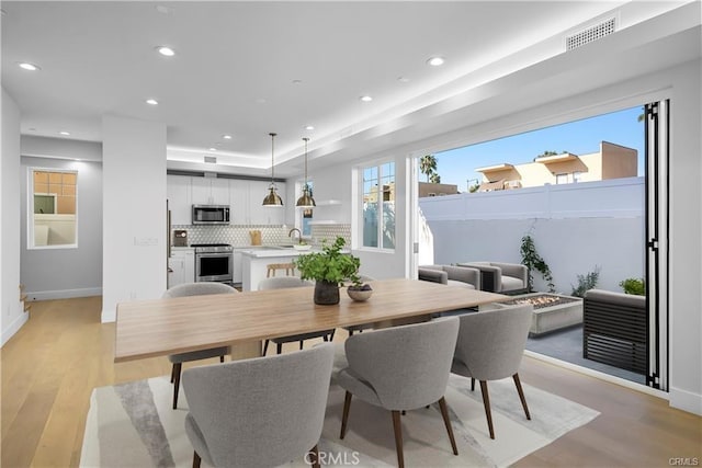 dining area featuring baseboards, recessed lighting, light wood-style flooring, and visible vents