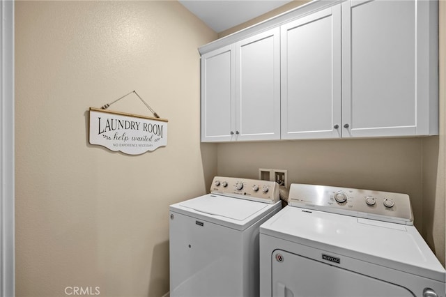 washroom featuring washing machine and clothes dryer and cabinet space