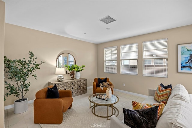 living area with light tile patterned floors, baseboards, and visible vents