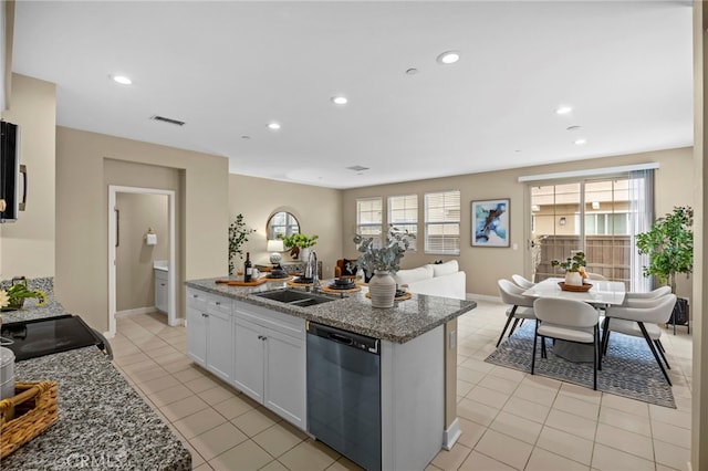 kitchen featuring recessed lighting, a healthy amount of sunlight, black appliances, and a sink