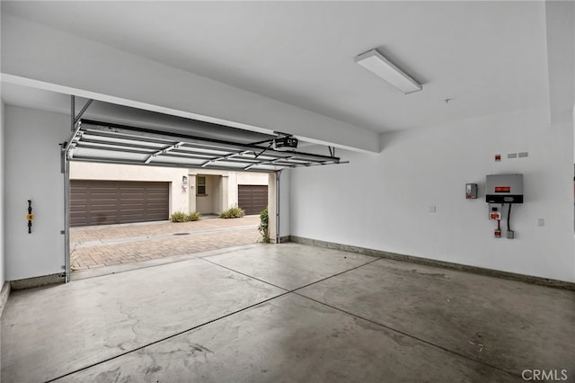 garage featuring baseboards and a garage door opener