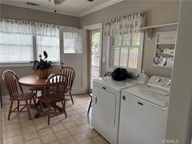 laundry area featuring laundry area, ornamental molding, light floors, visible vents, and washing machine and clothes dryer
