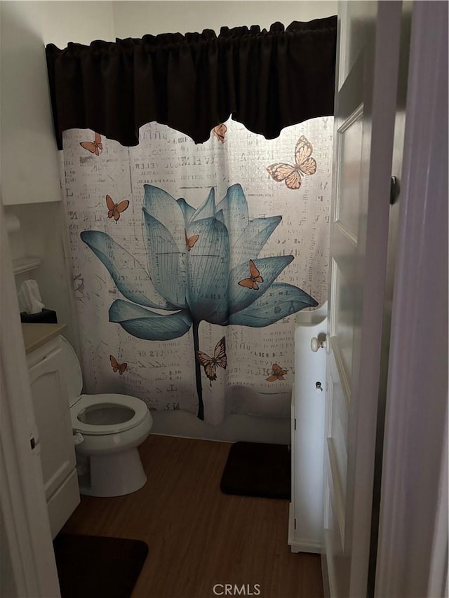 bathroom featuring toilet and wood finished floors