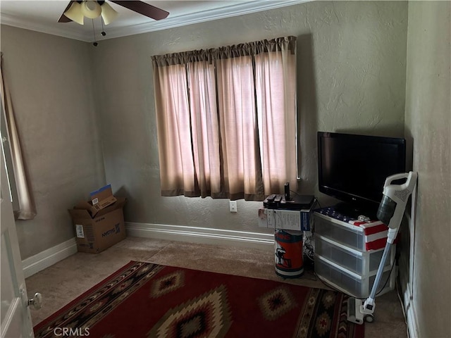 interior space with baseboards, ornamental molding, and a ceiling fan