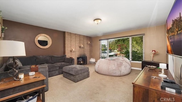 carpeted living area featuring baseboards and a brick fireplace