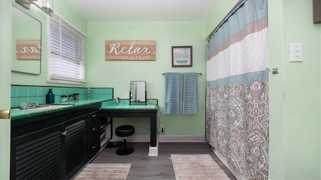 full bath with baseboards, vanity, a shower with shower curtain, and wood finished floors