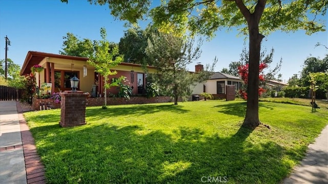 ranch-style home featuring a front yard and fence