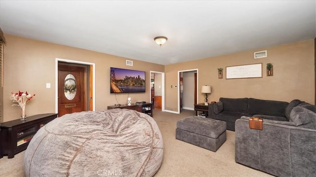 carpeted living area featuring visible vents