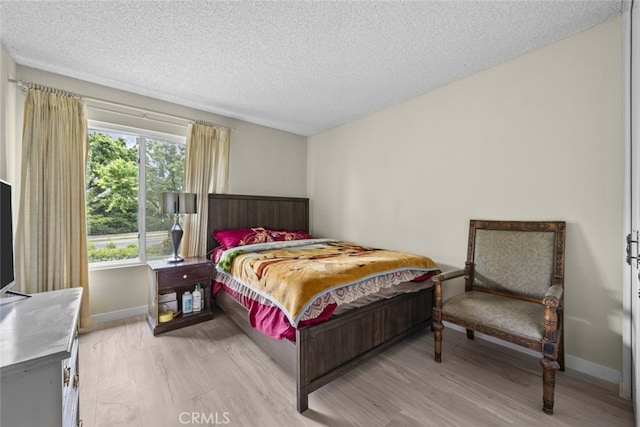 10661 Baton Rouge Ave, Porter Ranch, CA 91326 - bedroom with baseboards, light wood-style flooring, and a textured ceiling