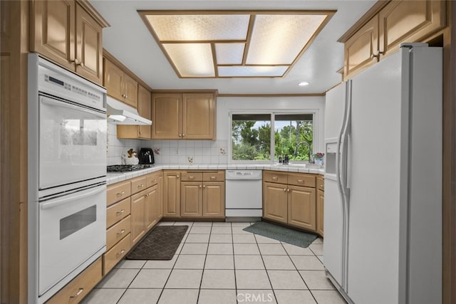 10661 Baton Rouge Ave, Porter Ranch, CA 91326 - kitchen featuring under cabinet range hood, white appliances, tile countertops, and tasteful backsplash