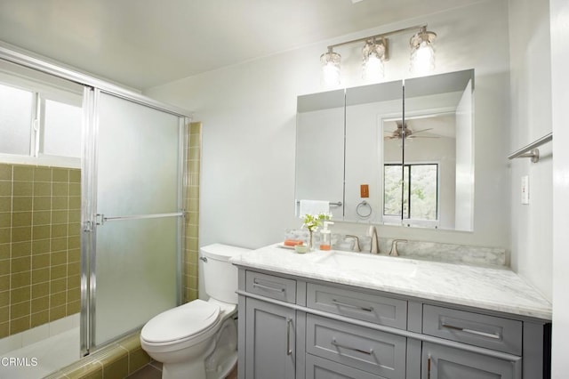 full bathroom featuring vanity, toilet, a shower stall, and ceiling fan