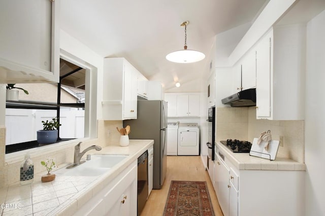 kitchen featuring white cabinetry, black appliances, independent washer and dryer, and under cabinet range hood