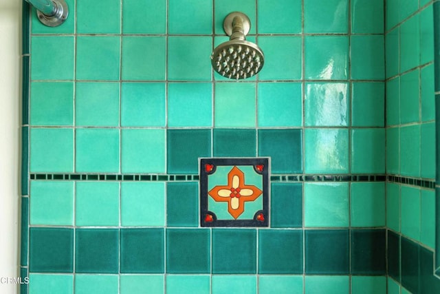 interior details featuring tiled shower