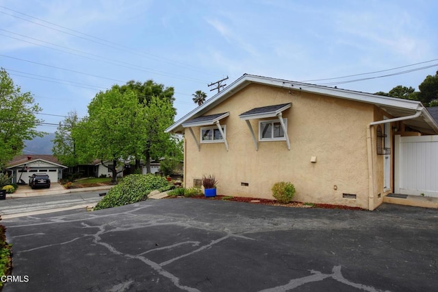 view of property exterior featuring stucco siding and crawl space