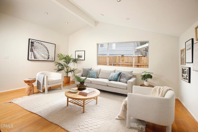 living room with baseboards, vaulted ceiling with beams, and wood finished floors