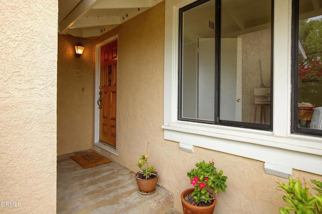 entrance to property with stucco siding
