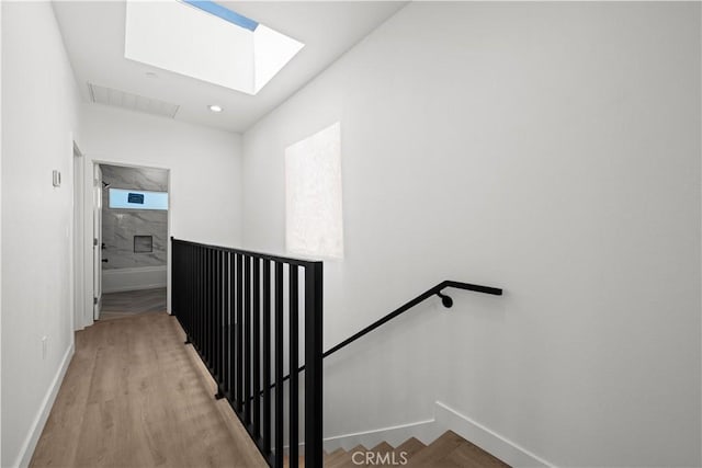 648 N Boyle Ave, Los Angeles, CA 90033 - stairs with wood finished floors, visible vents, baseboards, and a skylight