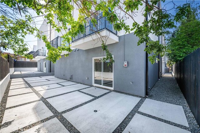 648 N Boyle Ave, Los Angeles, CA 90033 - back of property featuring fence private yard, a patio, stucco siding, and a balcony