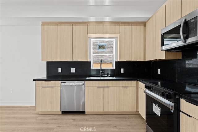 648 N Boyle Ave, Los Angeles, CA 90033 - kitchen with dark countertops, light brown cabinets, stainless steel appliances, and a sink