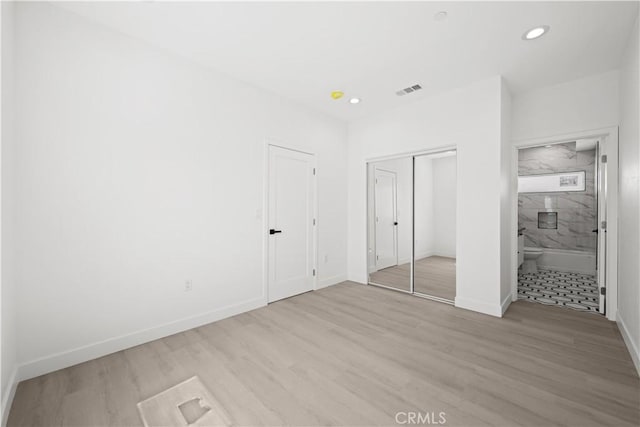 648 N Boyle Ave, Los Angeles, CA 90033 - unfurnished bedroom featuring a closet, wood finished floors, visible vents, recessed lighting, and baseboards