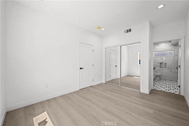 648 N Boyle Ave, Los Angeles, CA 90033 - unfurnished bedroom featuring wood finished floors, visible vents, recessed lighting, connected bathroom, and baseboards