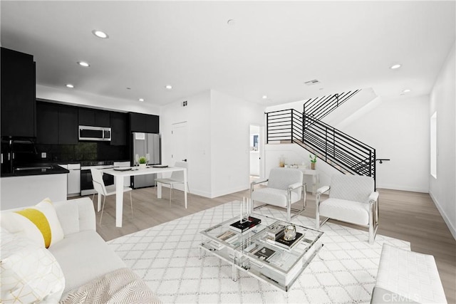 648 N Boyle Ave, Los Angeles, CA 90033 - living room featuring light wood-type flooring, stairway, baseboards, and recessed lighting