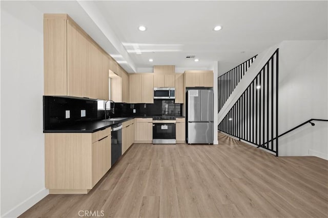 648 N Boyle Ave, Los Angeles, CA 90033 - kitchen featuring a sink, stainless steel appliances, light wood-style flooring, light brown cabinets, and dark countertops