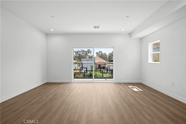 648 N Boyle Ave, Los Angeles, CA 90033 - unfurnished room with baseboards, a wealth of natural light, visible vents, and wood finished floors